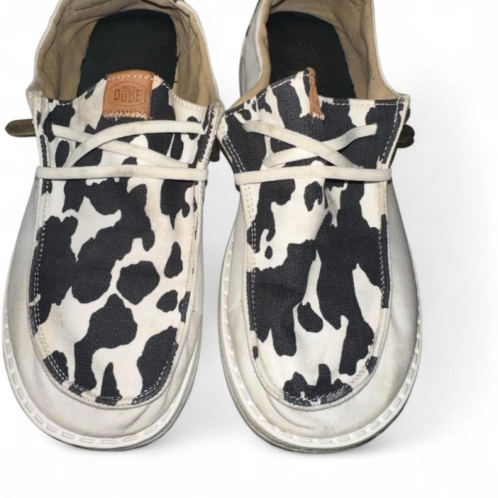 white & black cow print HeyDudes slip-on shoes